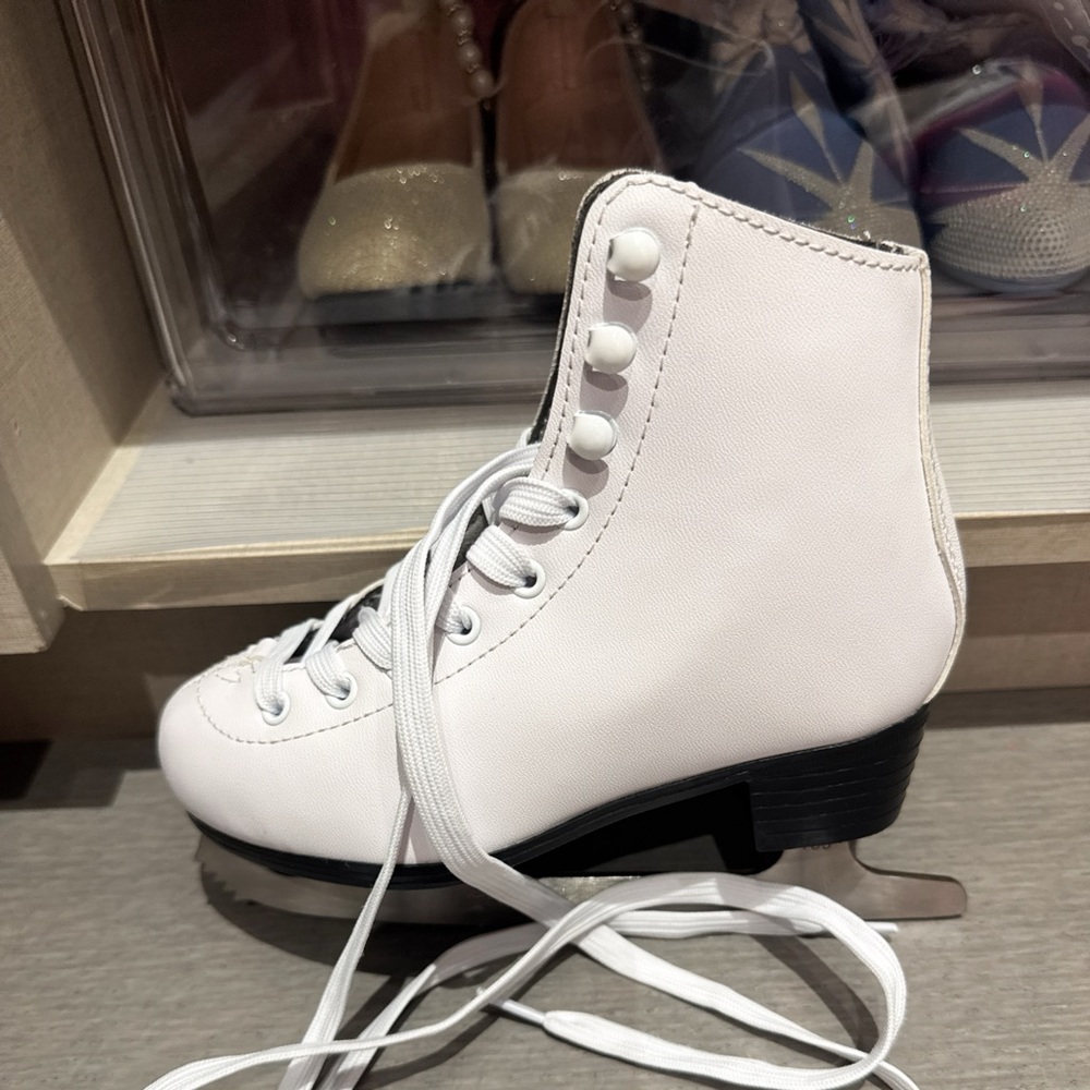 White figure skates with black accents, white laces. Size 12y